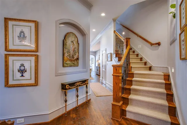 a view of staircase with lots of frames and frames on wall