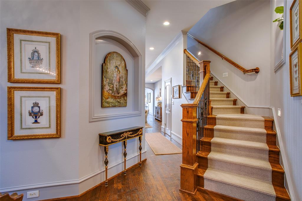 4139 Herschel Avenue Dallas, TX 75219 - Photo 8 of 30 a view of staircase with lots of frames and frames on wall