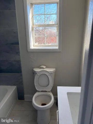 a bathroom with a toilet a sink and bathtub