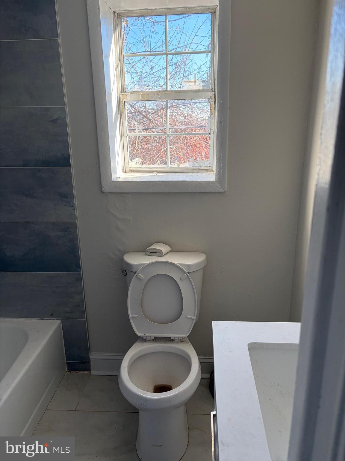 305 South Calhoun Street Baltimore, MD 21223 - Photo 12 of 13 a bathroom with a toilet a sink and bathtub