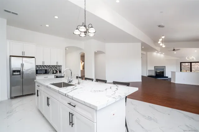 a large white kitchen with a large window