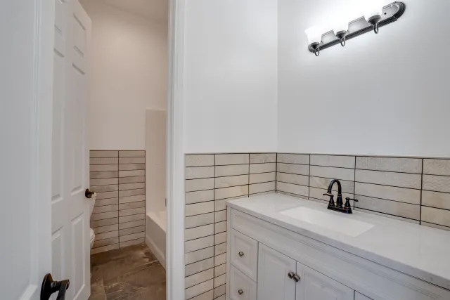 a bathroom with a double vanity sink and mirror