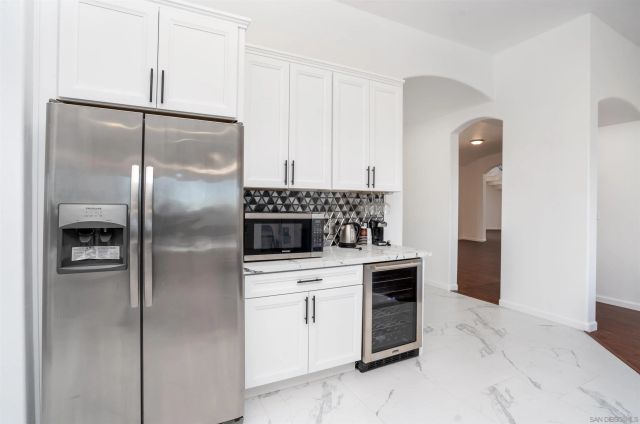 a white kitchen with a sink and a stove