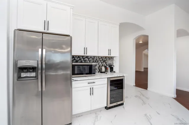 a white kitchen with a sink and a stove