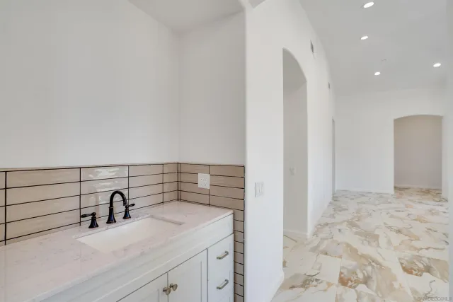 a bathroom with a sink a toilet and a mirror