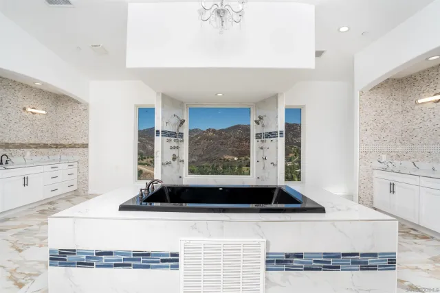 a view of a room with wooden floor and a ceiling fan