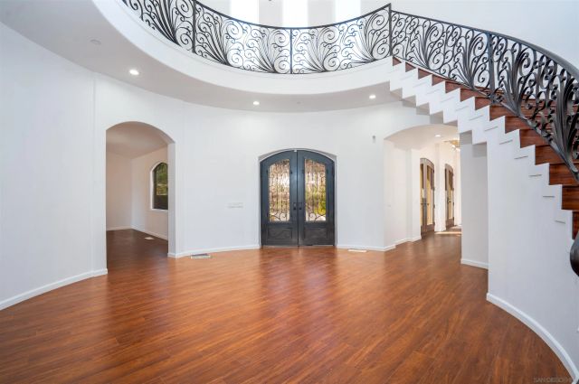 a view of a livingroom with wooden floor and a fireplace