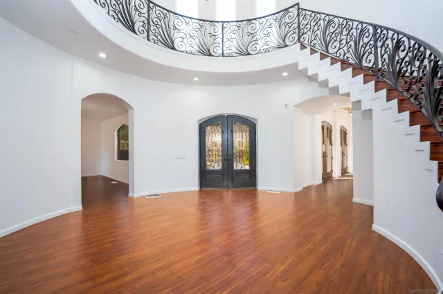 a view of a livingroom with wooden floor and a fireplace
