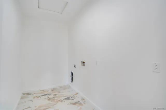 an empty room with wooden floor closet and fan