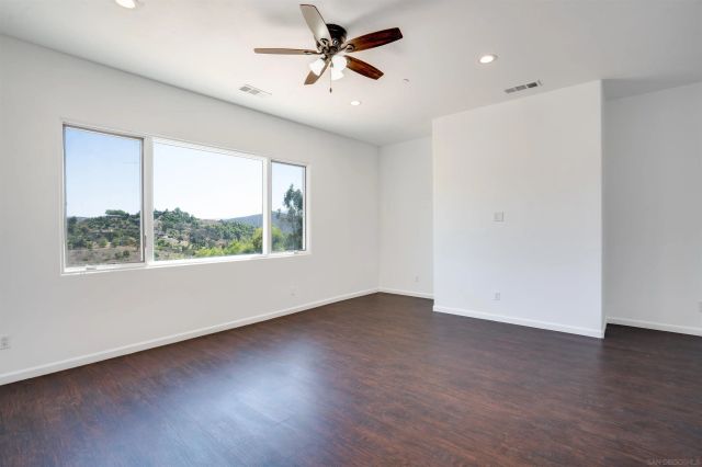 a view of a balcony with wooden floor and fence