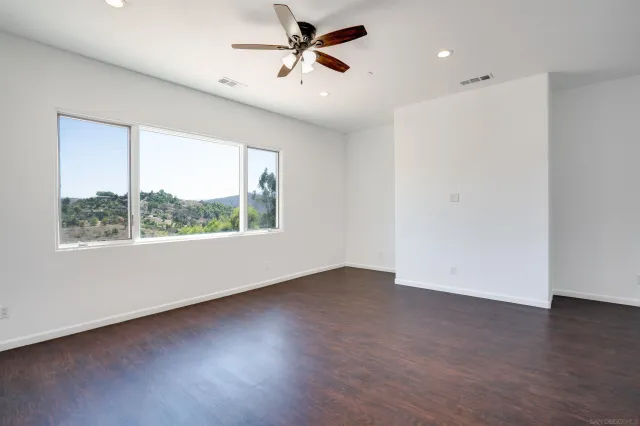 a view of a balcony with wooden floor and fence