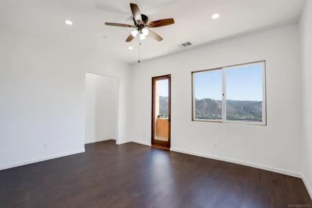 an aerial view of a house with a yard and a large tree