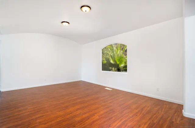 a kitchen with stainless steel appliances a dining table chairs and a refrigerator