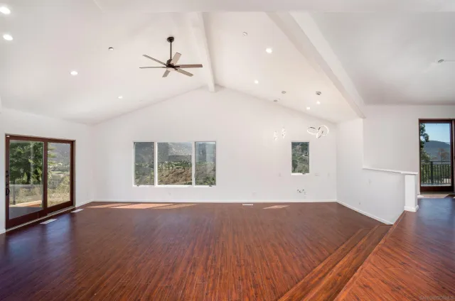 a large white kitchen with a sink and dishwasher