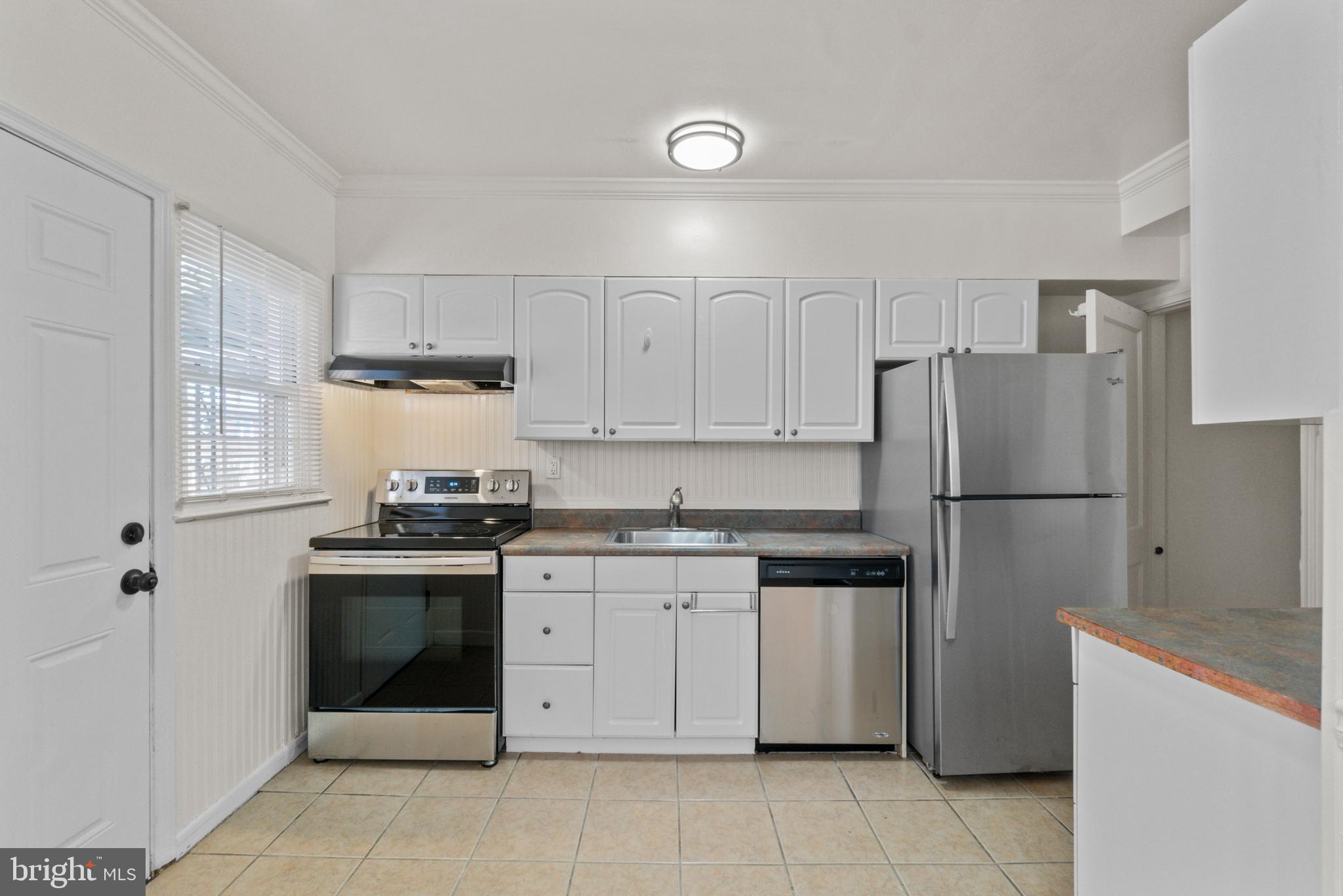 8340 Edgedale Road Baltimore, MD 21234 - Photo 12 of 33 a kitchen with stainless steel appliances granite countertop a stove a refrigerator and a sink