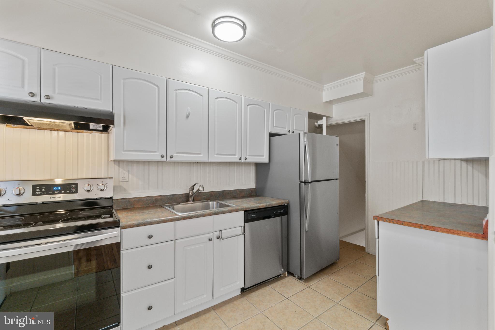 8340 Edgedale Road Baltimore, MD 21234 - Photo 13 of 33 a kitchen with stainless steel appliances granite countertop a refrigerator sink and cabinets