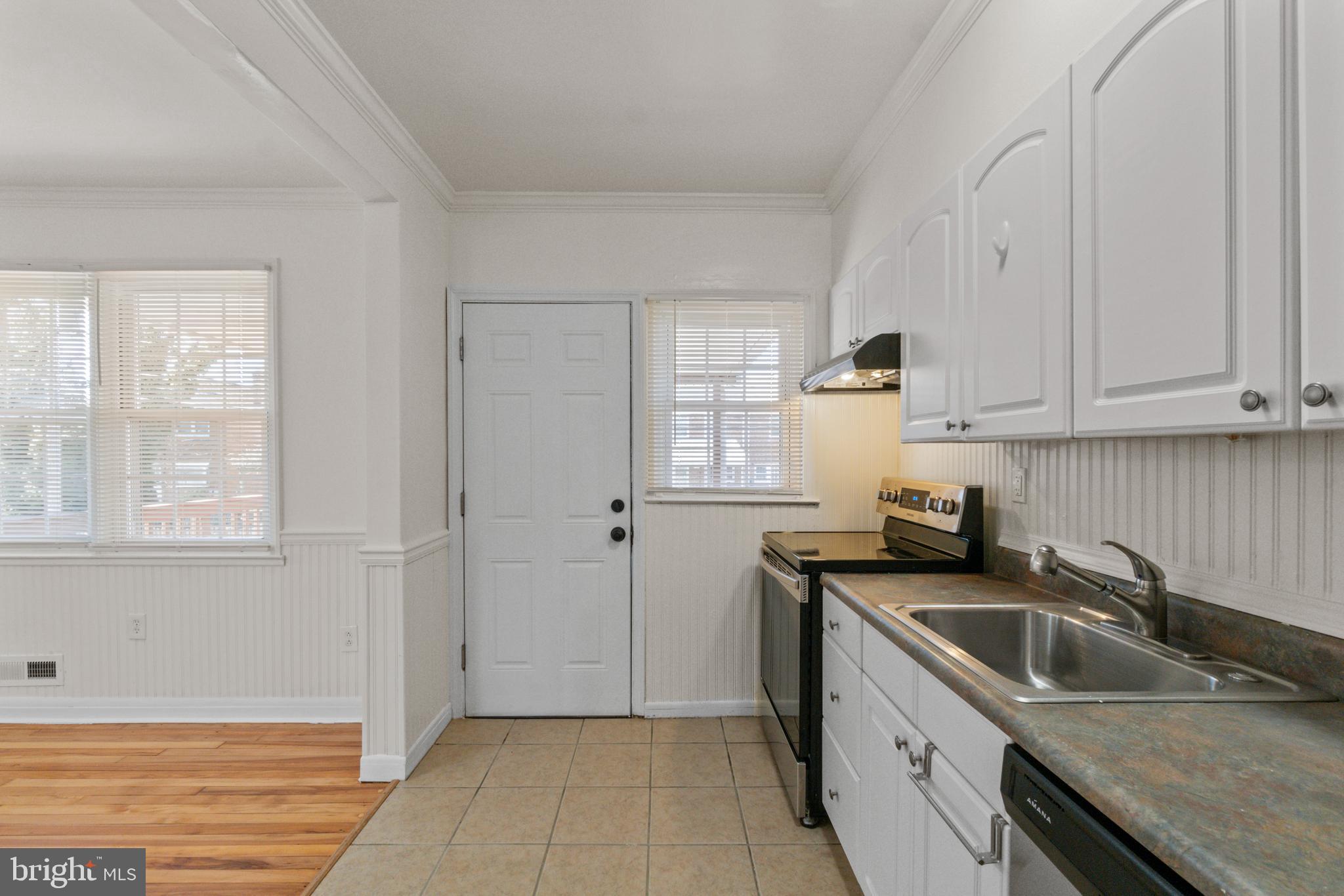 8340 Edgedale Road Baltimore, MD 21234 - Photo 14 of 33 a kitchen that has a sink and a stove