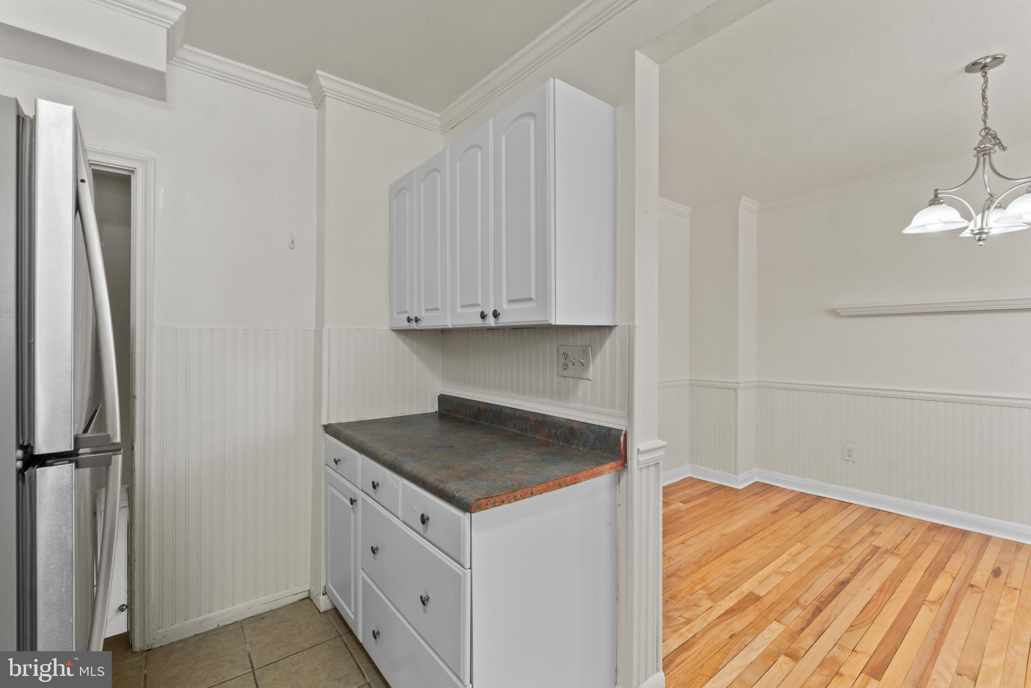 8340 Edgedale Road Baltimore, MD 21234 - Photo 16 of 33 a kitchen with white cabinets and sink