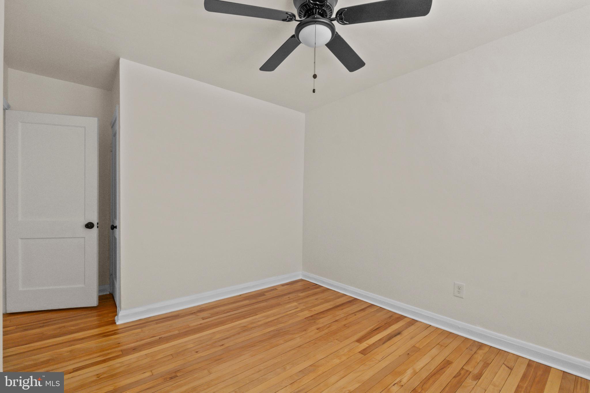 8340 Edgedale Road Baltimore, MD 21234 - Photo 20 of 33 a view of a room with wooden floor and white walls