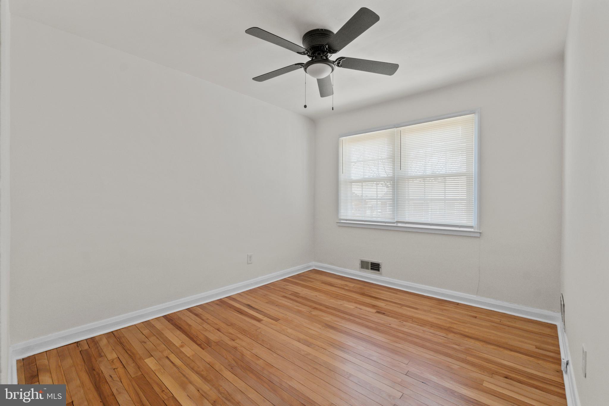 8340 Edgedale Road Baltimore, MD 21234 - Photo 21 of 33 wooden floor in an empty room with a window