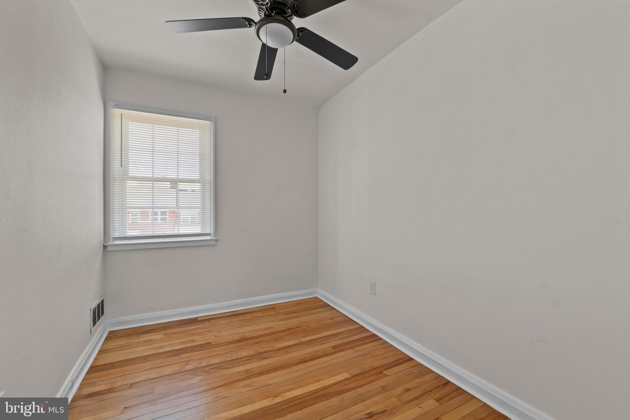 8340 Edgedale Road Baltimore, MD 21234 - Photo 23 of 33 a view of an empty room with wooden floor and a window