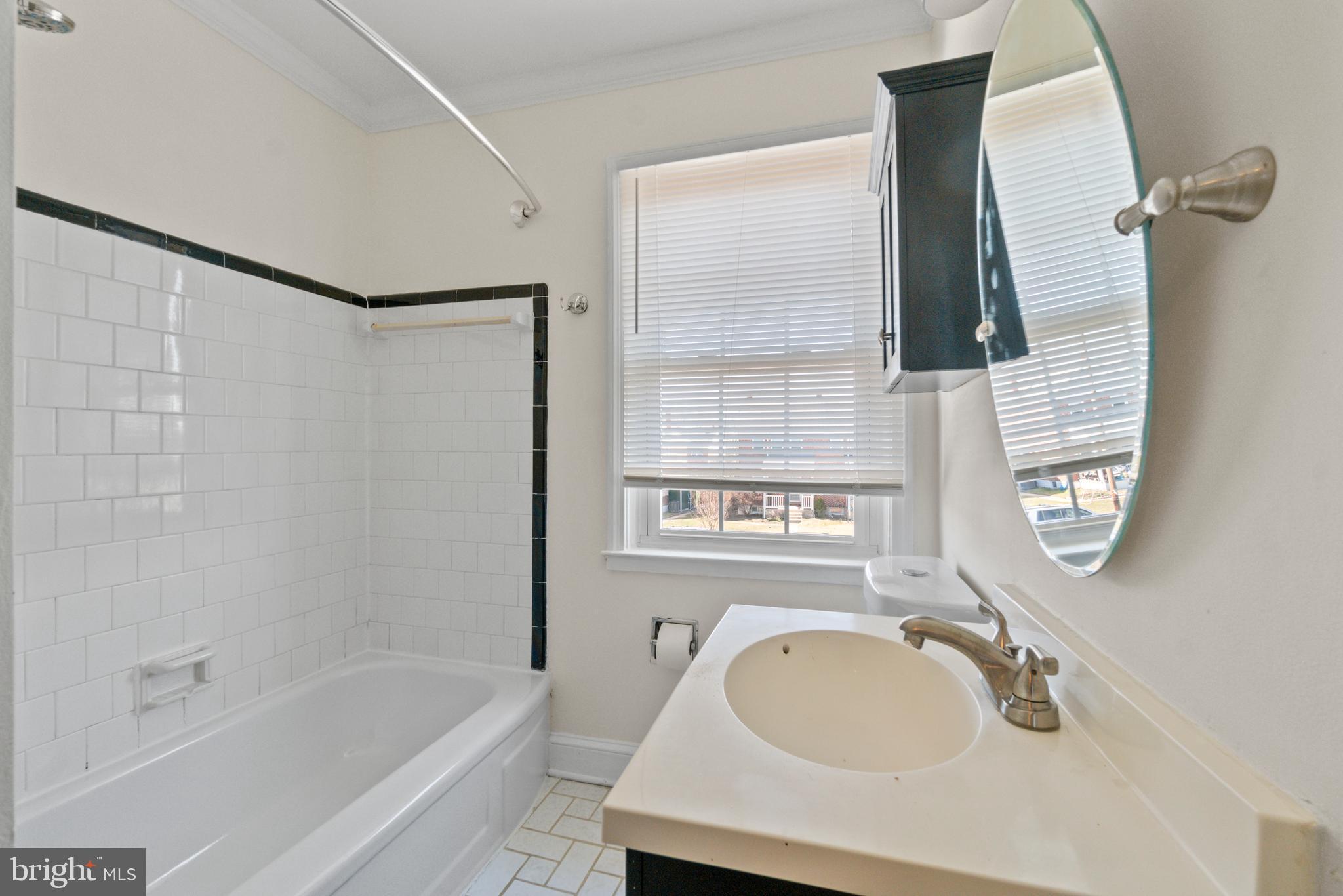 8340 Edgedale Road Baltimore, MD 21234 - Photo 24 of 33 a bathroom with a tub sink and mirror