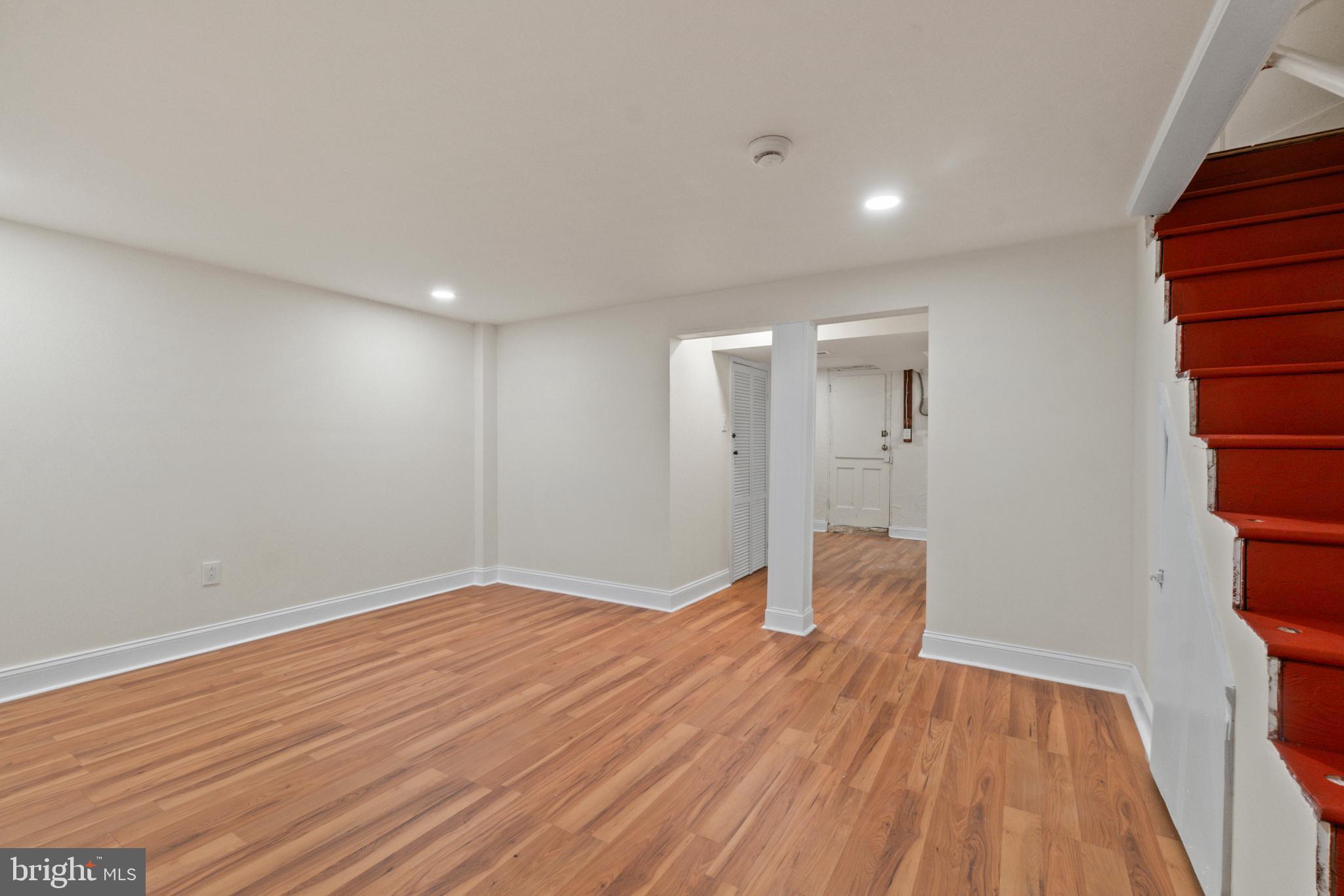 8340 Edgedale Road Baltimore, MD 21234 - Photo 26 of 33 a view of an empty room with wooden floor and a window