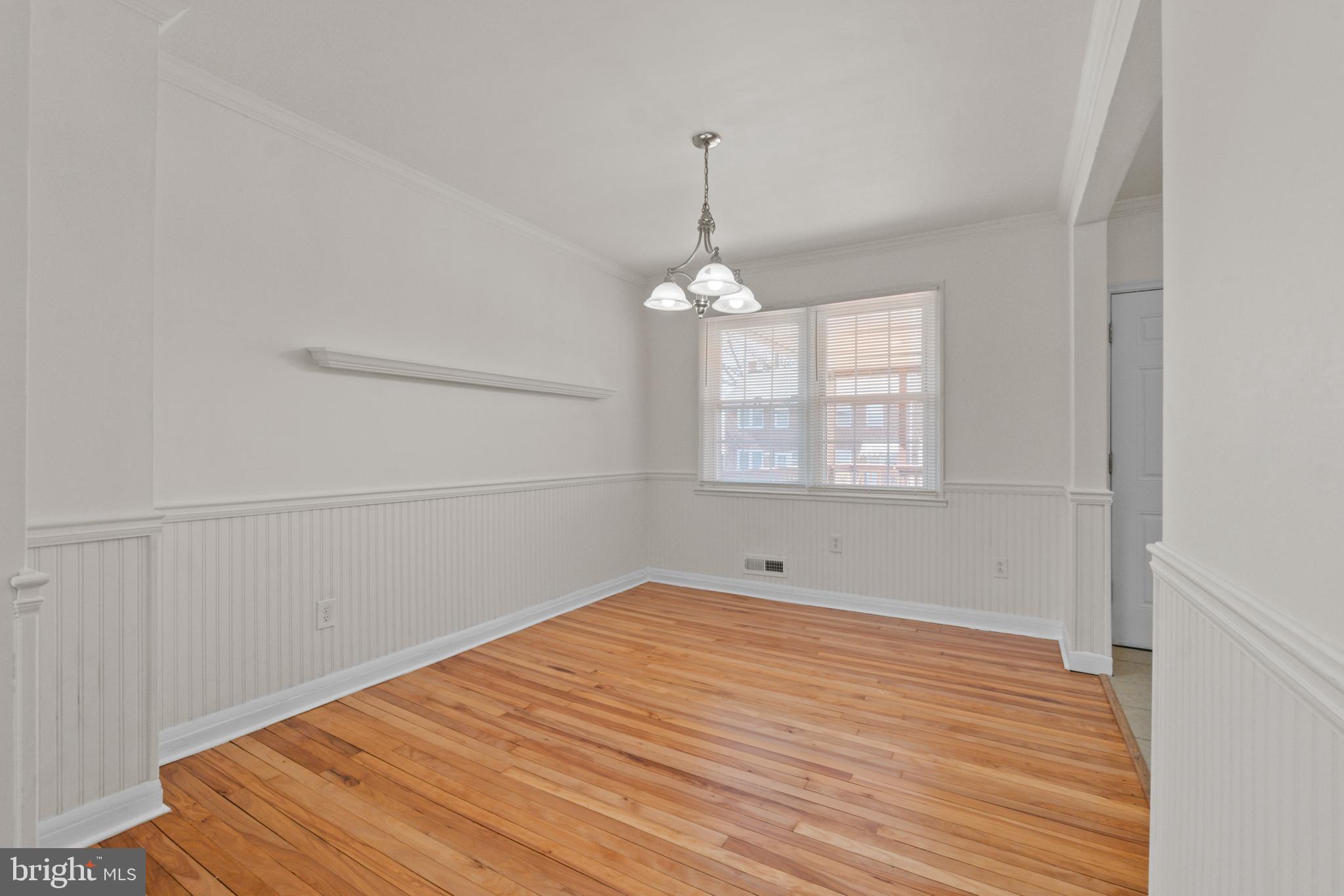 8340 Edgedale Road Baltimore, MD 21234 - Photo 8 of 33 a view of empty room with wooden floor and fan