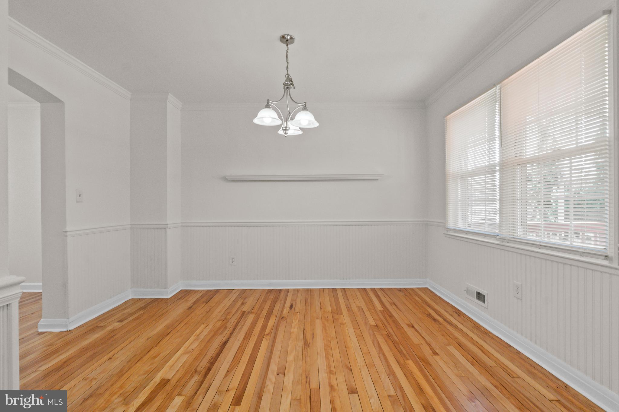 8340 Edgedale Road Baltimore, MD 21234 - Photo 9 of 33 a view of a room with wooden floor and exposed radiator