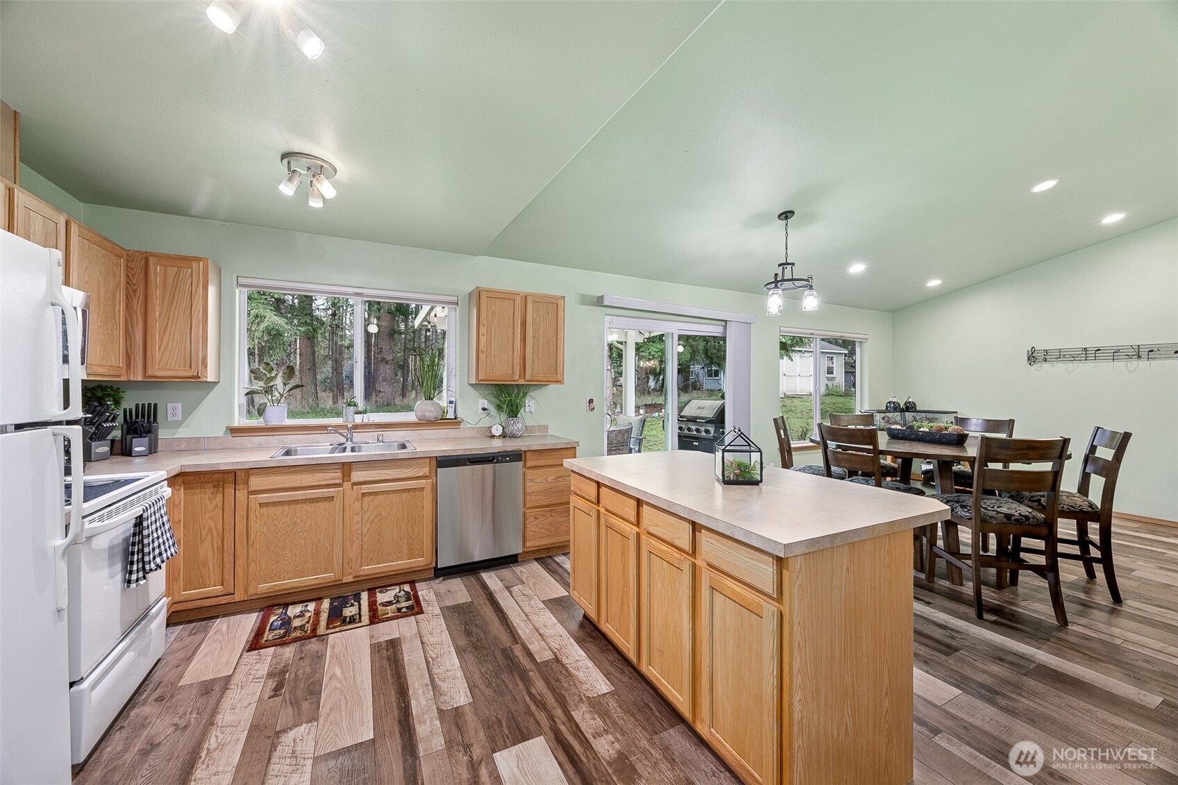 7510 191st Avenue Southwest Rochester, WA 98579 - Photo 12 of 28 a kitchen with sink stove and white cabinets