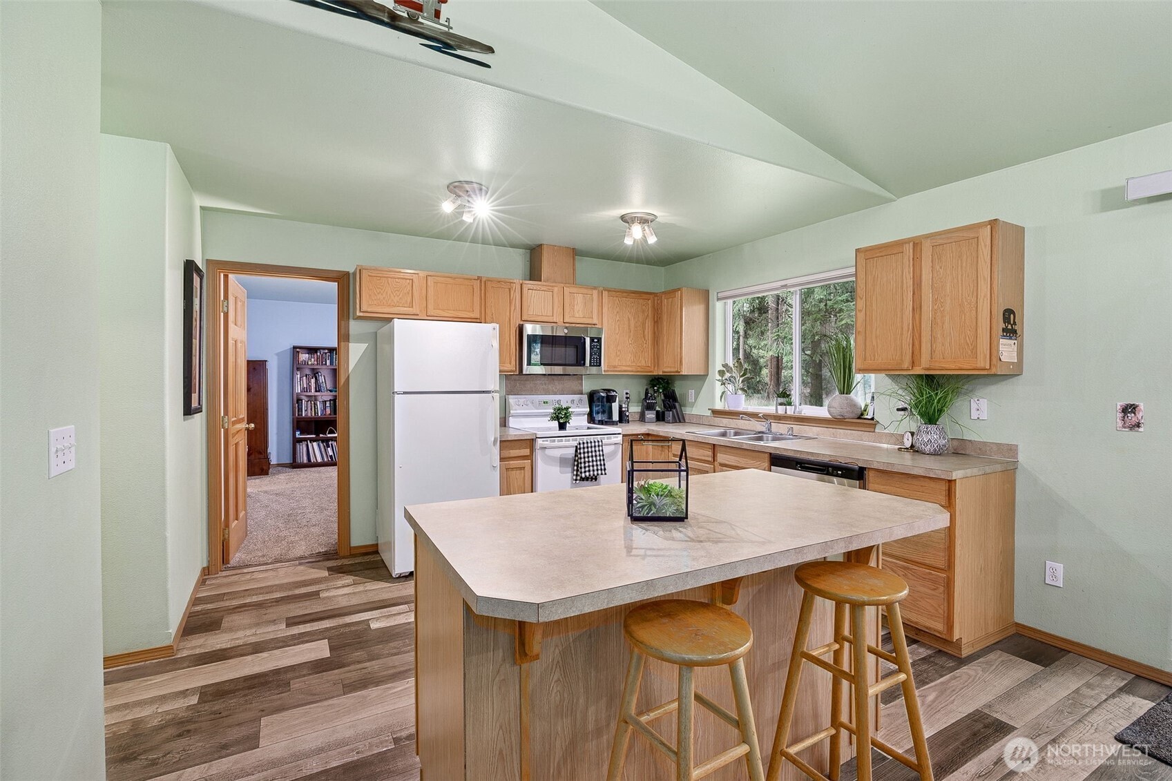 7510 191st Avenue Southwest Rochester, WA 98579 - Photo 14 of 28 a kitchen with stainless steel appliances granite countertop a sink refrigerator and cabinets