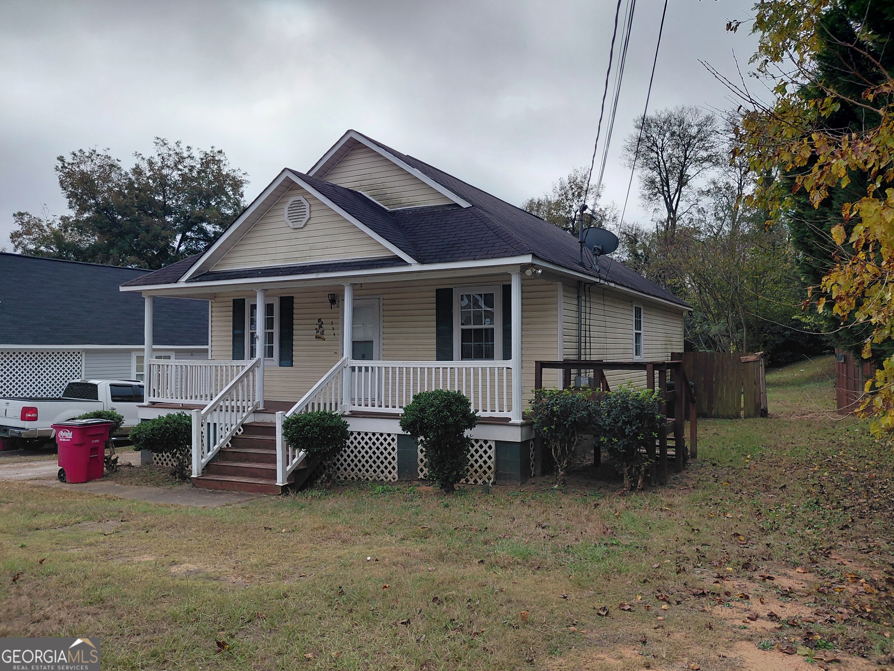 a view of a house with a patio and a yard