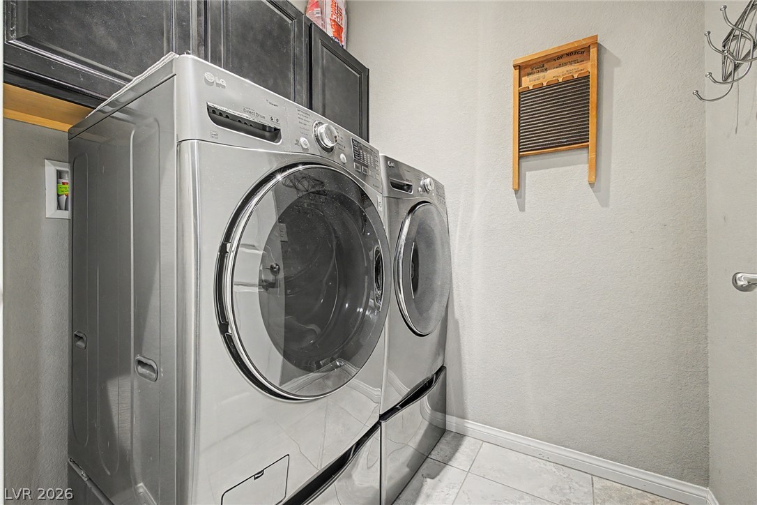 7415 Campbell Ranch Avenue Las Vegas, NV 89179 - Photo 41 of 52 Streamlined laundry area with convenient appliances and overhead cabinetry for optimal organization.