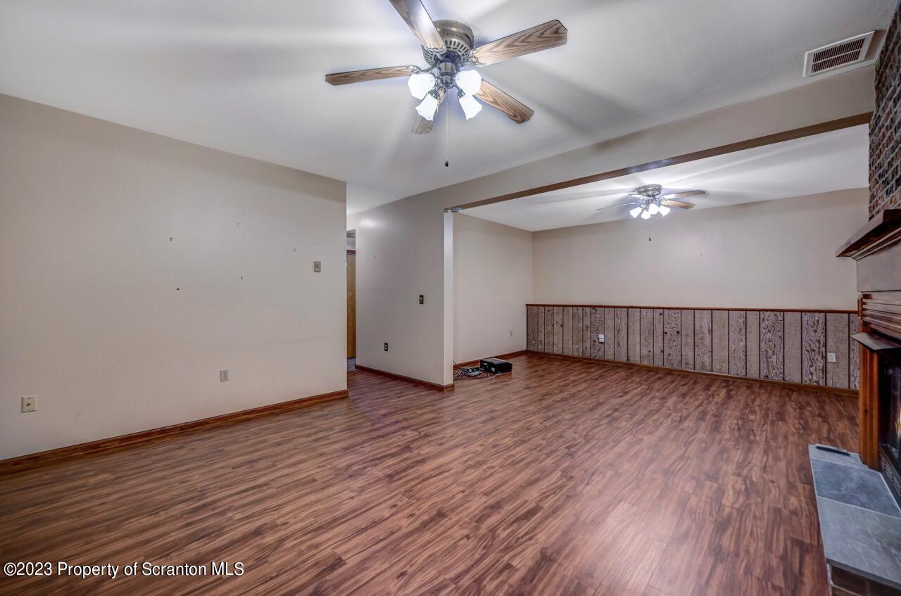 1370 Charles Road Lake Ariel, PA 18436 - Photo 54 of 70 a view of a livingroom with wooden floor and a ceiling fan