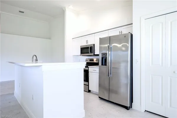 a kitchen with stainless steel appliances a refrigerator and a sink