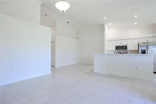a view of a kitchen with white cabinets
