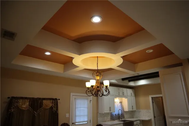 a view of a dining room with furniture and chandelier