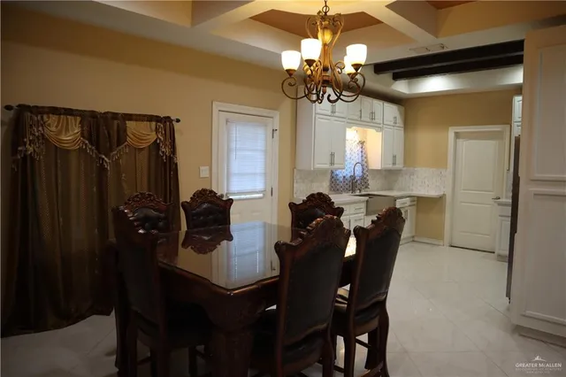 a kitchen with a dining table and chairs