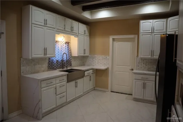 a kitchen with a refrigerator sink and stove