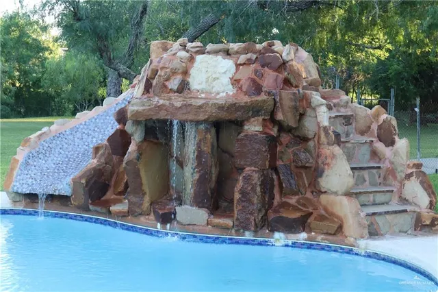 a view of a patio with couches chairs and a yard