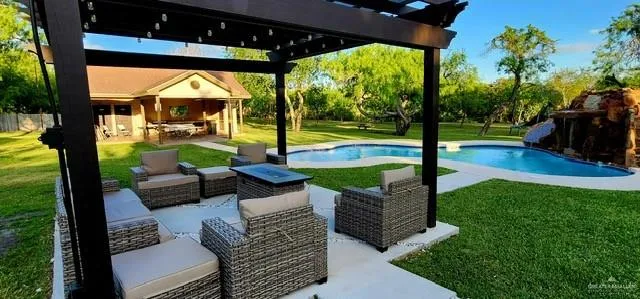 a view of a patio with a table and chairs under an umbrella