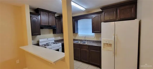 a kitchen with stainless steel appliances granite countertop a refrigerator and a stove