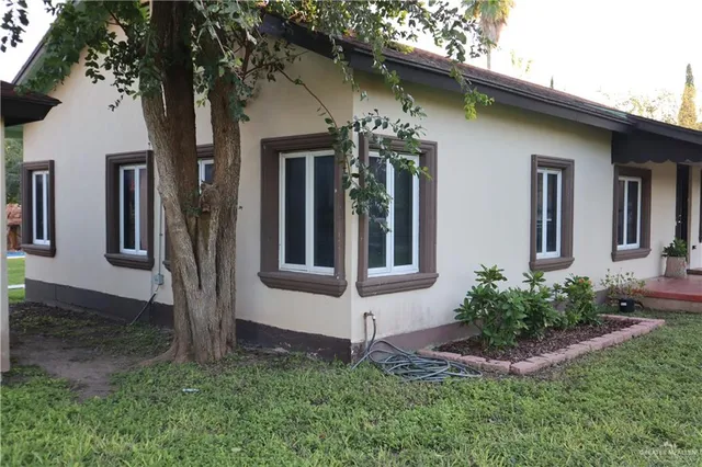 a view of a house with a yard and plants