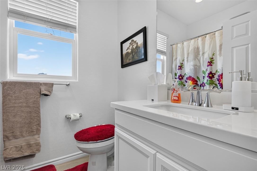 1824 Redland Ridge Street Henderson, NV 89002 - Photo 54 of 69 White cabinetry and countertops provide a crisp, clean aesthetic in this well-appointed bathroom.