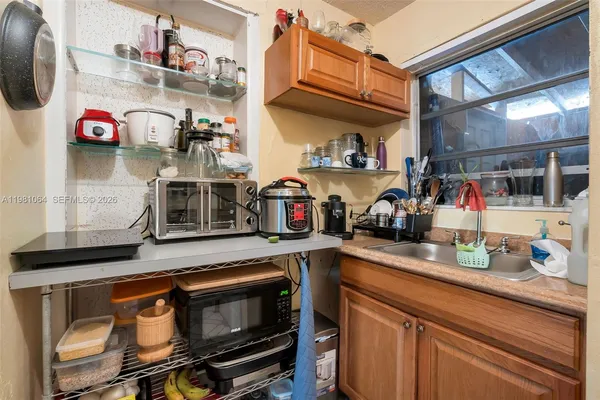 a kitchen with lots of clutter and cabinets