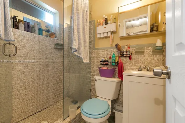 a bathroom with a toilet and a shower