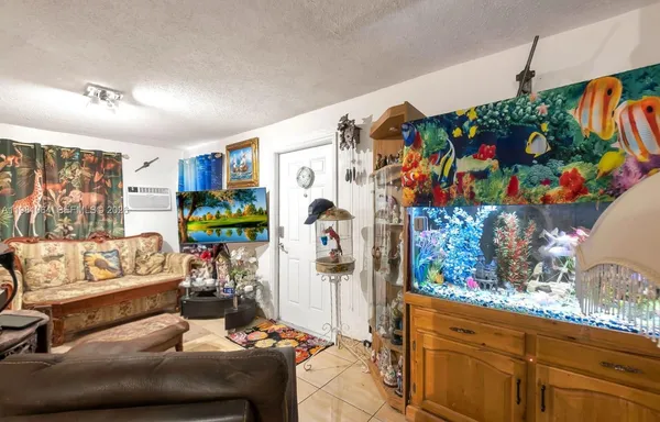 a living room with patio furniture and flowers