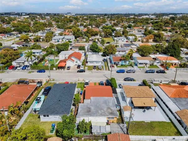 an aerial view of residential houses with outdoor space