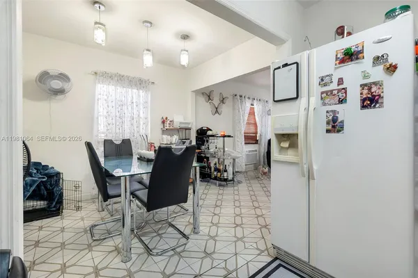 a dining room with furniture and window