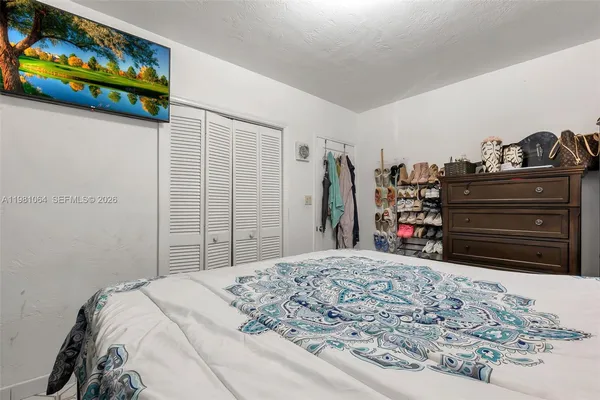 a bedroom with a bed and a mirror